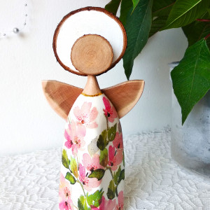 Anioł w sukience w różowe kwiatki.